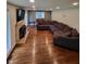 Spacious living room featuring hardwood floors, a fireplace, and large sectional sofa at 1231 E 88Th St, Indianapolis, IN 46240