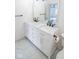 Double vanity bathroom with marble countertops and black matte fixtures at 2424 N Willow Way, Indianapolis, IN 46268