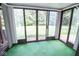 Sunroom with sliding glass doors and green carpet at 2424 N Willow Way, Indianapolis, IN 46268