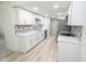 Modern white kitchen with new appliances and hexagonal tile backsplash at 2424 N Willow Way, Indianapolis, IN 46268