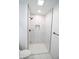 Large walk-in shower with marble tile and black fixtures at 2424 N Willow Way, Indianapolis, IN 46268