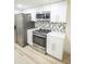 Modern white kitchen with stainless steel appliances at 2424 N Willow Way, Indianapolis, IN 46268