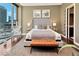 Main bedroom with plush bed and city views at 1 Virginia Ave # 703, Indianapolis, IN 46204