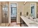 Modern bathroom with double sinks and glass shower at 1 Virginia Ave # 703, Indianapolis, IN 46204