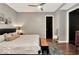 King-size bed in a well-lit bedroom with dark wood floors at 1 Virginia Ave # 703, Indianapolis, IN 46204