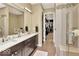 Elegant bathroom with double vanity and walk-in shower at 1 Virginia Ave # 703, Indianapolis, IN 46204