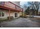 Stone patio with built-in bench, access to pool, and a deck above at 6835 Fox Lake S Dr, Indianapolis, IN 46278