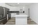 Modern kitchen with white cabinets, island, and stainless steel appliances at 22133 State Road 37 N, Noblesville, IN 46060