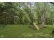 Large backyard with playset, grassy area, and trees at 22133 State Road 37 N, Noblesville, IN 46060