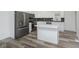 Modern kitchen with white cabinets, island, and stainless steel appliances at 22133 State Road 37 N, Noblesville, IN 46060