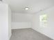 Spacious bedroom with grey carpet and a window with blinds at 22133 State Road 37 N, Noblesville, IN 46060