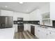 Modern kitchen with white cabinets, stainless steel appliances, and hexagon backsplash at 22133 State Road 37 N, Noblesville, IN 46060