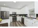 Modern kitchen with white cabinets and dark appliances at 22133 State Road 37 N, Noblesville, IN 46060