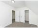 Bedroom with grey carpet, double closets, and access to another room at 22133 State Road 37 N, Noblesville, IN 46060