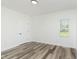 Well-lit bedroom featuring wood-look floors and a window at 22133 State Road 37 N, Noblesville, IN 46060