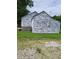 House exterior undergoing renovation, showing stonework and new siding at 3025 S Keystone Ave, Indianapolis, IN 46237