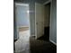 A hallway with gray walls and brown carpet, leading to bedrooms at 642 N Oxford St, Indianapolis, IN 46201
