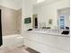 Modern bathroom with double vanity and a large walk-in shower at 877 N East St # 104, Indianapolis, IN 46202