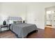 Bright bedroom with hardwood floors and an en-suite bathroom at 877 N East St # 104, Indianapolis, IN 46202