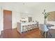 Modern kitchen with white cabinets, marble island, and hardwood floors at 877 N East St # 104, Indianapolis, IN 46202