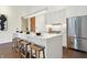 Contemporary kitchen featuring white cabinetry, a large island, and stainless steel appliances at 877 N East St # 104, Indianapolis, IN 46202