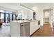 Open concept kitchen island with white cabinets and stainless steel appliances at 877 N East St # 104, Indianapolis, IN 46202