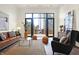 Living area with floor to ceiling windows and access to patio at 877 N East St # 104, Indianapolis, IN 46202