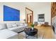 Spacious living area with large artwork, comfortable seating, and hardwood floors at 877 N East St # 104, Indianapolis, IN 46202