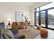 Bright living room with leather sofa, large windows and patio access at 877 N East St # 104, Indianapolis, IN 46202