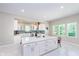 Bright kitchen with white cabinets, quartz countertops, and teal backsplash at 372 Foxboro Cir, Avon, IN 46123