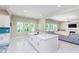 Open concept kitchen with island, white cabinets and view to living room at 372 Foxboro Cir, Avon, IN 46123