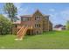 Brick house exterior with a deck and stairs leading to backyard at 372 Foxboro Cir, Avon, IN 46123