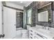 Modern bathroom with dark marble tile and white vanity at 372 Foxboro Cir, Avon, IN 46123