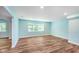 Finished basement with light blue walls and wood floors at 372 Foxboro Cir, Avon, IN 46123