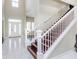 Modern staircase with dark wood and white railing at 372 Foxboro Cir, Avon, IN 46123