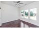 Bedroom with hardwood floors and three windows showing a backyard view at 372 Foxboro Cir, Avon, IN 46123