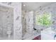Modern bathroom with marble tile and a soaking tub at 372 Foxboro Cir, Avon, IN 46123