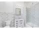 Modern bathroom with geometric tile, white vanity, and shower/tub combo at 372 Foxboro Cir, Avon, IN 46123