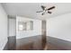 Bright bedroom with dark hardwood floors and a view to the dining room at 372 Foxboro Cir, Avon, IN 46123