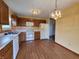 Eat-in kitchen with oak cabinets and white appliances at 1096 Bumblebee Way, Greenfield, IN 46140