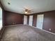 Bright bedroom with ceiling fan and multiple doors at 1096 Bumblebee Way, Greenfield, IN 46140