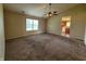 Open living room with a view into the kitchen and large window at 1096 Bumblebee Way, Greenfield, IN 46140