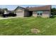 Tan brick ranch home with a black truck parked in the driveway at 1096 Bumblebee Way, Greenfield, IN 46140