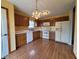 Kitchen with oak cabinets, white appliances, and wood flooring at 1096 Bumblebee Way, Greenfield, IN 46140