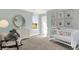 Bedroom with crib, rocking chair, and animal wall art at 3422 Wetherby Pl, Danville, IN 46122