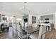 Open concept dining room with modern chandelier and grey chairs at 3422 Wetherby Pl, Danville, IN 46122