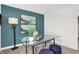 Home office featuring glass desk and teal accent wall at 3422 Wetherby Pl, Danville, IN 46122