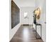 Bright entryway with hardwood floors, a modern console table, and large wall art at 3422 Wetherby Pl, Danville, IN 46122