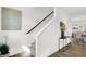 Elegant staircase with dark wood railing and a light-filled landing at 3422 Wetherby Pl, Danville, IN 46122