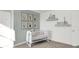 Bedroom featuring a crib, neutral color scheme, and ample sunlight at 3422 Wetherby Pl, Danville, IN 46122